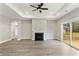 Open living space featuring a fireplace, tray ceiling, and sliding door access to deck at 1110 N Middleton Dr. Nw, Calabash, NC 28467