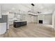 An open-concept living space with a modern kitchen island, a fireplace, and ample natural light at 1110 N Middleton Dr. Nw, Calabash, NC 28467