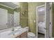 Stylish bathroom featuring modern fixtures, textured wallpaper, and convenient access to the bedroom at 113B 13Th Ave. N, Surfside Beach, SC 29575