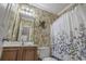 Charming bathroom featuring a decorative mirror and colorful wallpaper at 113B 13Th Ave. N, Surfside Beach, SC 29575