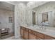 Stylish bathroom with a double sink vanity, decorative wallpaper, and a separate tiled shower area at 113B 13Th Ave. N, Surfside Beach, SC 29575