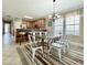 Dining area adjacent to kitchen with a glass table, seating for six, and stylish furnishings at 113B 13Th Ave. N, Surfside Beach, SC 29575