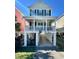 Charming two-story stilt home with a covered porch, perfect for enjoying the coastal breeze at 113B 13Th Ave. N, Surfside Beach, SC 29575