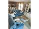 Cozy living room with tile floors, a comfortable blue sofa, and a large built-in entertainment center at 113B 13Th Ave. N, Surfside Beach, SC 29575