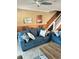 Comfortable living room with staircase, tile flooring, a blue sofa, and beach-themed decor at 113B 13Th Ave. N, Surfside Beach, SC 29575