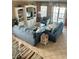 Comfortable living room with blue sofas, neutral rug, and sliding glass doors to outdoor space at 113B 13Th Ave. N, Surfside Beach, SC 29575