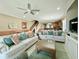 Bright living room with comfortable white sofas and open access to the kitchen and stairs at 113B 13Th Ave. N, Surfside Beach, SC 29575