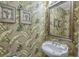 Comfortable powder room with banana leaf wallpaper, wall art, mirror, and a white sink at 113B 13Th Ave. N, Surfside Beach, SC 29575