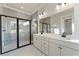 Spacious bathroom featuring a walk-in shower, double sink vanity, tile flooring, and large mirror at 115 S Middleton Dr. Nw, Calabash, NC 28467