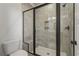 Modern bathroom with a glass enclosed shower with seating and tiled walls at 115 S Middleton Dr. Nw, Calabash, NC 28467