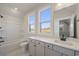 Bright bathroom with white cabinets, marble floors, bathtub and window at 115 S Middleton Dr. Nw, Calabash, NC 28467