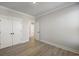 Empty bedroom with wood flooring and white closet doors at 115 S Middleton Dr. Nw, Calabash, NC 28467