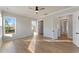 Bright bedroom with hardwood floors, a ceiling fan, closet, and view of the outdoors at 115 S Middleton Dr. Nw, Calabash, NC 28467