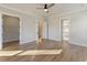 Bedroom featuring hardwood floors, a ceiling fan, closet, and two entry doors at 115 S Middleton Dr. Nw, Calabash, NC 28467