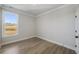 Bright bedroom with wood flooring, natural light, and white trim at 115 S Middleton Dr. Nw, Calabash, NC 28467