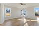 Sunlit bedroom with multiple windows, hardwood floors, and neutral color palette at 115 S Middleton Dr. Nw, Calabash, NC 28467