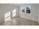 Bedroom with beautiful natural light featuring two windows and wood flooring at 115 S Middleton Dr. Nw, Calabash, NC 28467