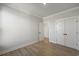 Spacious bedroom with wood floors and white doors leading to other rooms at 115 S Middleton Dr. Nw, Calabash, NC 28467