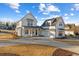 Beautiful modern farmhouse with white siding and a spacious driveway at 115 S Middleton Dr. Nw, Calabash, NC 28467