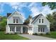 Charming home with light blue siding, black roof, and inviting front porch at 115 S Middleton Dr. Nw, Calabash, NC 28467