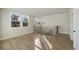 Hallway area featuring hardwood floors, staircase, wrought iron railings, and natural light at 115 S Middleton Dr. Nw, Calabash, NC 28467