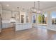 Modern kitchen featuring white cabinets, stainless steel appliances, a center island, and sliding glass doors at 115 S Middleton Dr. Nw, Calabash, NC 28467