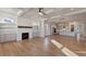 Open-concept living area featuring a fireplace and modern kitchen at 115 S Middleton Dr. Nw, Calabash, NC 28467