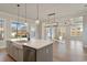 Open-concept living space with lots of natural light, hardwood floors, and modern light fixtures at 115 S Middleton Dr. Nw, Calabash, NC 28467