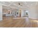 Spacious living room featuring an open layout, coffered ceiling, hardwood floors, and seamless access to the kitchen at 115 S Middleton Dr. Nw, Calabash, NC 28467