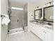 Elegant bathroom featuring a glass-enclosed shower and double vanities with granite countertops at 1241 Lady Bird Way, North Myrtle Beach, SC 29582