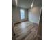 Bright bedroom with laminate flooring and a large window overlooking the neighborhood at 1241 Lady Bird Way, North Myrtle Beach, SC 29582