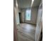 Well-lit bedroom with laminate flooring and an adjacent walk-in closet at 1241 Lady Bird Way, North Myrtle Beach, SC 29582