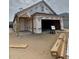 Exterior shot of an unfinished home with a garage and a porch at 1241 Lady Bird Way, North Myrtle Beach, SC 29582