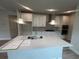 Modern kitchen with granite countertops, white cabinets, stainless steel appliances, and a center island at 1241 Lady Bird Way, North Myrtle Beach, SC 29582