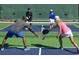 People enjoying an active game of pickleball on a well-maintained outdoor court within the community at 1241 Lady Bird Way, North Myrtle Beach, SC 29582