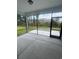 Relaxing screened-in porch with concrete flooring and peaceful views of the backyard and treeline at 1241 Lady Bird Way, North Myrtle Beach, SC 29582