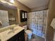 Well-lit bathroom with vanity and seashell shower curtain at 1261 Pineridge St., Conway, SC 29527