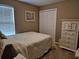 Comfortable bedroom with a quilted bedspread, double closet, and matching dresser at 1261 Pineridge St., Conway, SC 29527