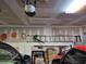 Organized garage space with an attic access panel, ladder and tools storage on the walls at 1261 Pineridge St., Conway, SC 29527