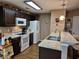 Well-lit kitchen features dark cabinets, modern appliances, and granite countertops at 1261 Pineridge St., Conway, SC 29527