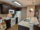 Well-lit kitchen features dark cabinets, modern appliances, and granite countertops at 1261 Pineridge St., Conway, SC 29527