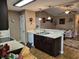 Bright, eat-in kitchen with dark cabinets, granite countertops, and stainless-steel dishwasher at 1261 Pineridge St., Conway, SC 29527