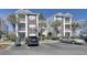 Condo building exterior featuring well-maintained landscaping and ample parking spaces at 1294 River Oaks Dr. # 6E, Myrtle Beach, SC 29579