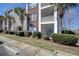 Exterior view showcasing the building's architectural details and attractive landscaping at 1294 River Oaks Dr. # 6E, Myrtle Beach, SC 29579