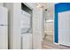Convenient laundry area with stacked washer and dryer and view of hall bathroom at 1294 River Oaks Dr. # 6E, Myrtle Beach, SC 29579