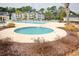 Community pool area with a hot tub and lush landscaping with shrubs at 1294 River Oaks Dr. # 6E, Myrtle Beach, SC 29579