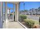 View from covered porch reveals a bright landscape and community parking at 1294 River Oaks Dr. # 6E, Myrtle Beach, SC 29579