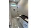 Modern bathroom with marble-style tile, a walk-in shower, and vanity with black countertop at 135 Low Country Loop, Murrells Inlet, SC 29576