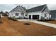 Well-designed home with a spacious front yard, two-car garage, and appealing landscaping at 135 Low Country Loop, Murrells Inlet, SC 29576