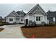 Charming single-Gathering home showcasing a well-manicured lawn, inviting entrance, and two-car garage at 135 Low Country Loop, Murrells Inlet, SC 29576